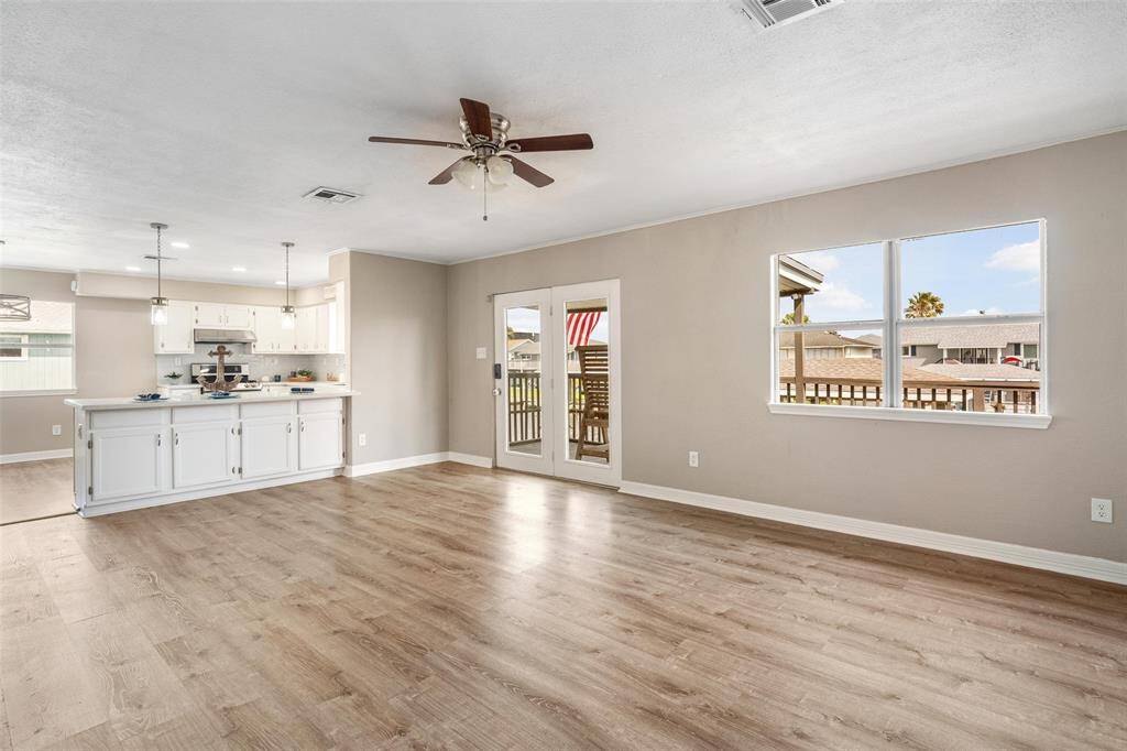 The floors are beautifully updated. The kitchen has been updated and shows extra storage in the breakfast bar