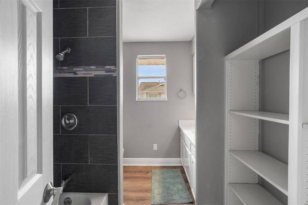 The upstairs bathroom has been updated with custom tile and has tons of storage area