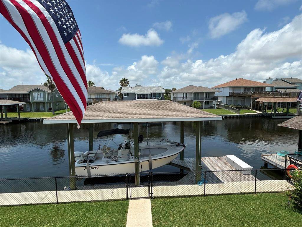 Water side of the home. Notice all decking and sidewalks have cool decking. Custom landscaping for privacy