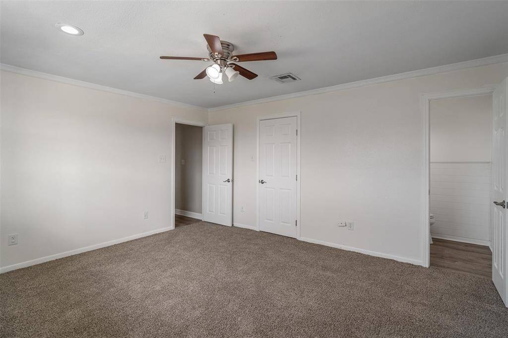 The primary bedroom has a half bath and a walk in closet