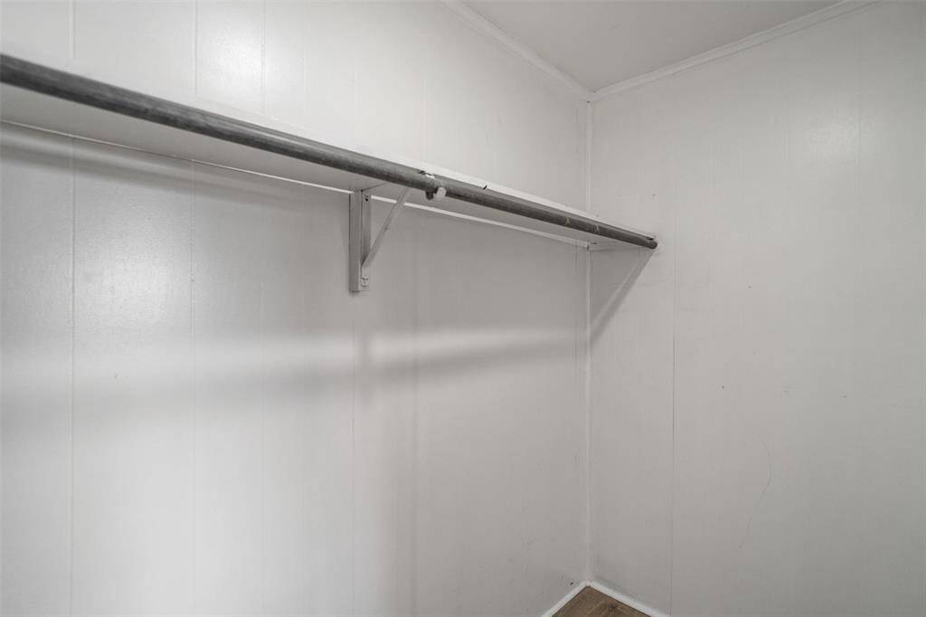 Primary bedroom walk in closet