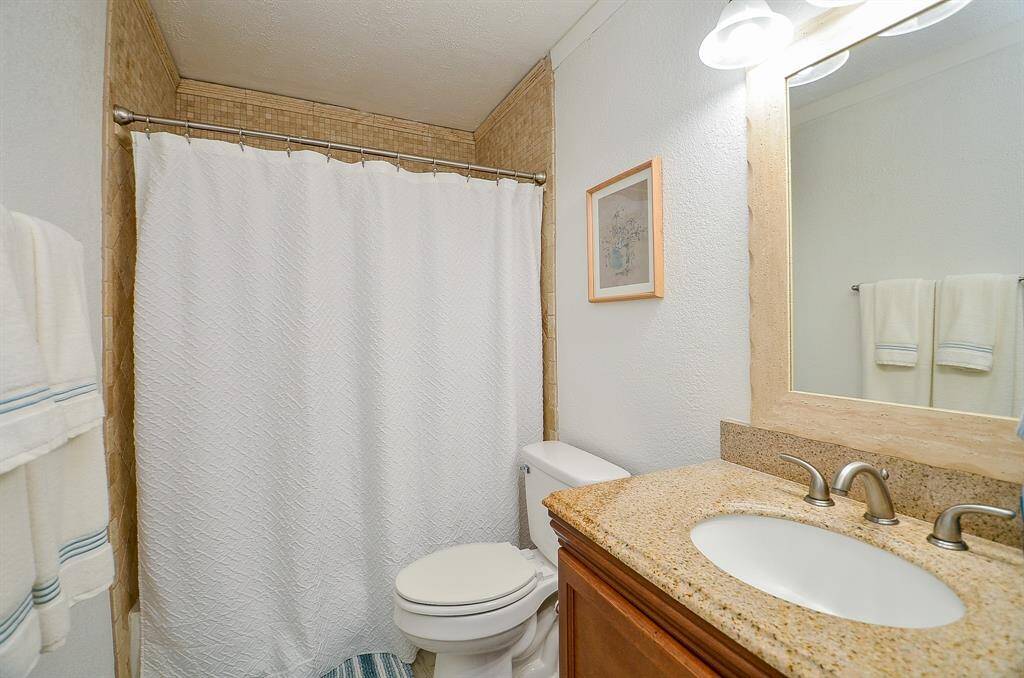 A well-appointed secondary bath with modern finishes and a tub-shower combination.