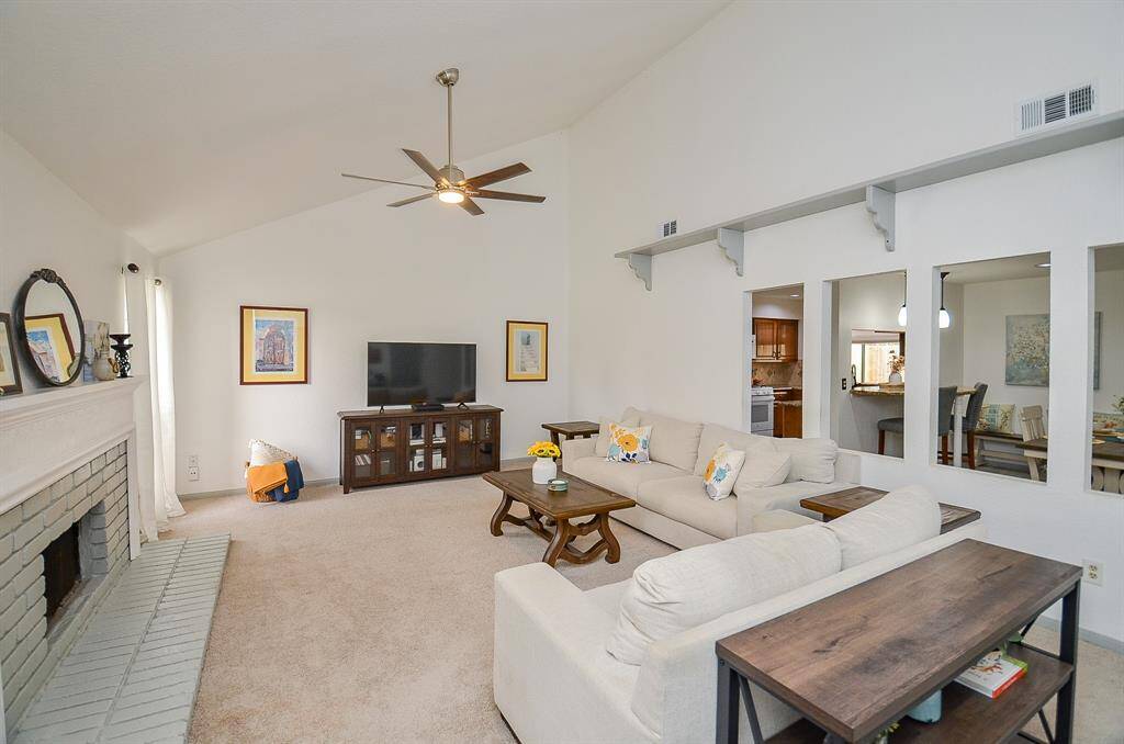 The open-concept design seamlessly connects to the kitchen and dining areas, perfect for entertaining and everyday living.