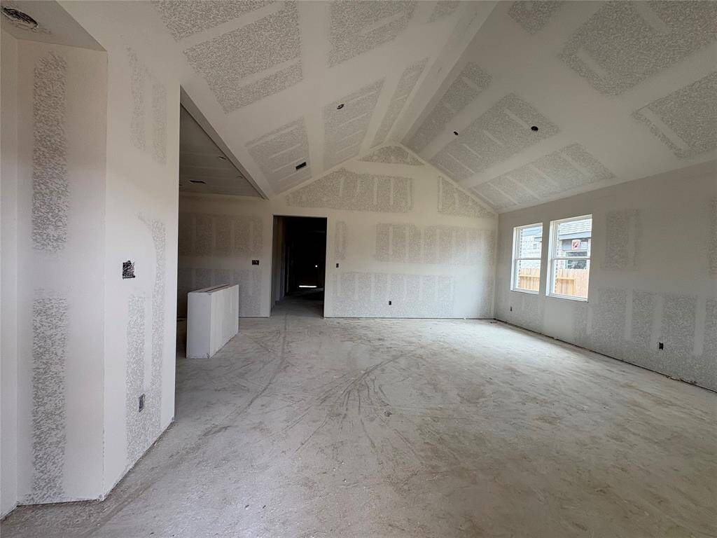 Open great room and dining area with vaulted ceilings