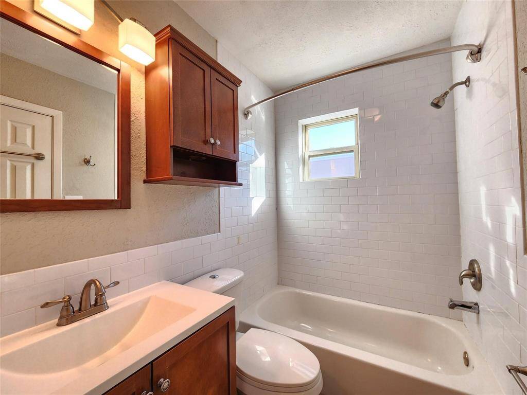 Upstairs secondary bath with tub and shower serves the oversized bedrooms.