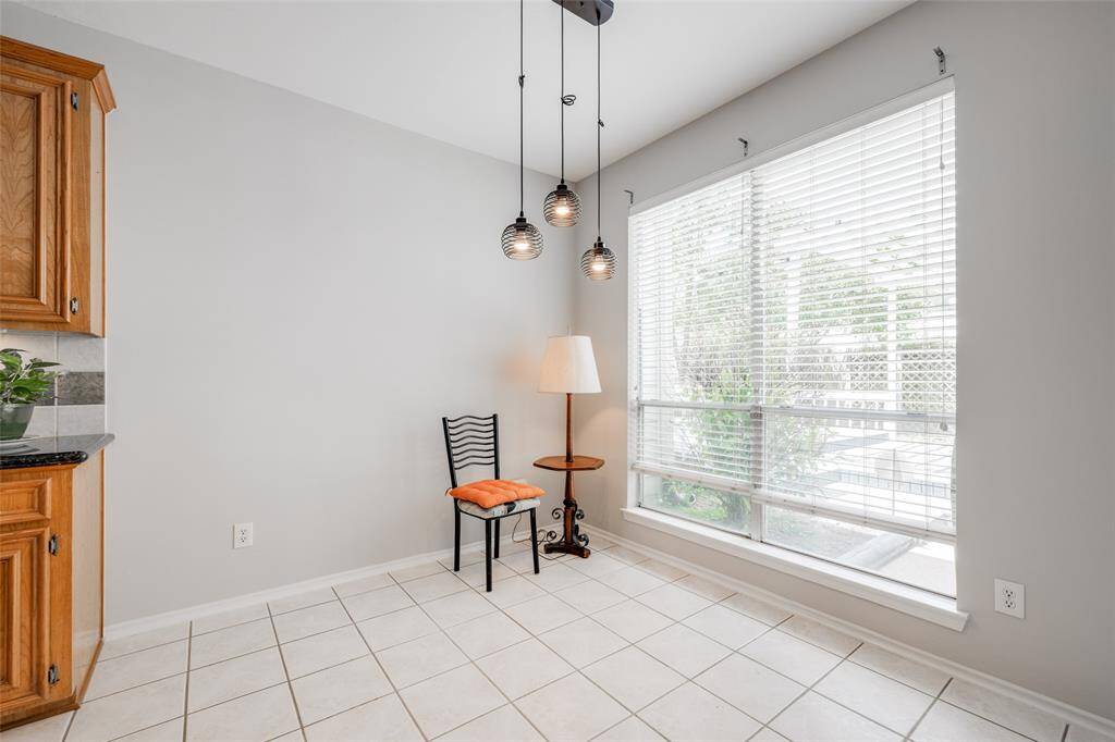 Breakfast room with modern black chandelier, window out to back yard