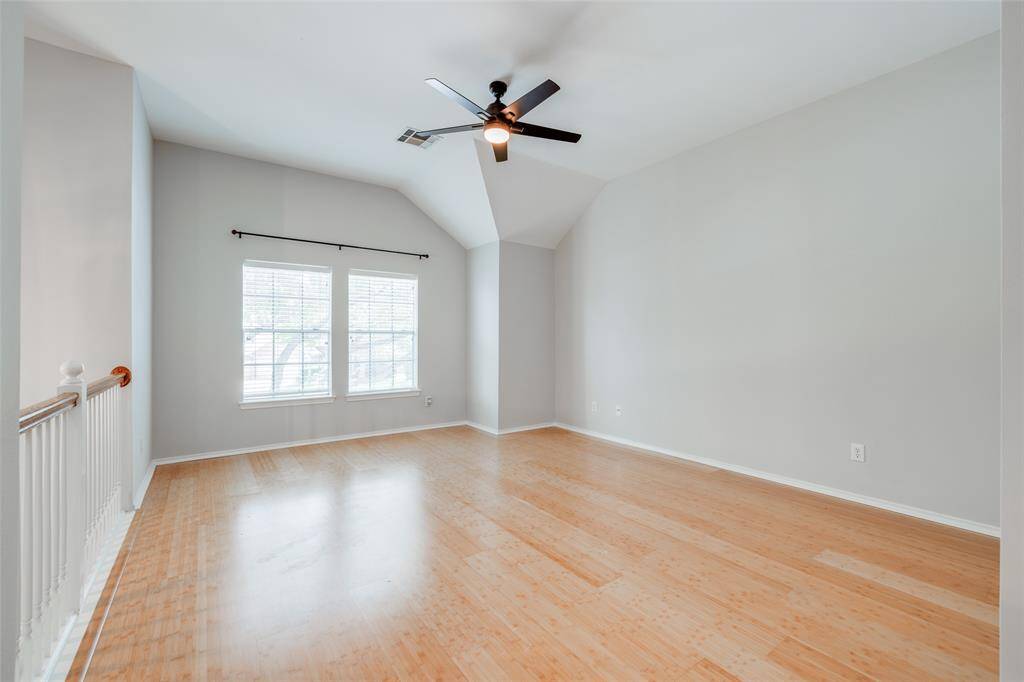Game room upstairs offering accented by Bamboo wood floors, raised ceilings, new ceiling fan with light fixture and open to the entry below.