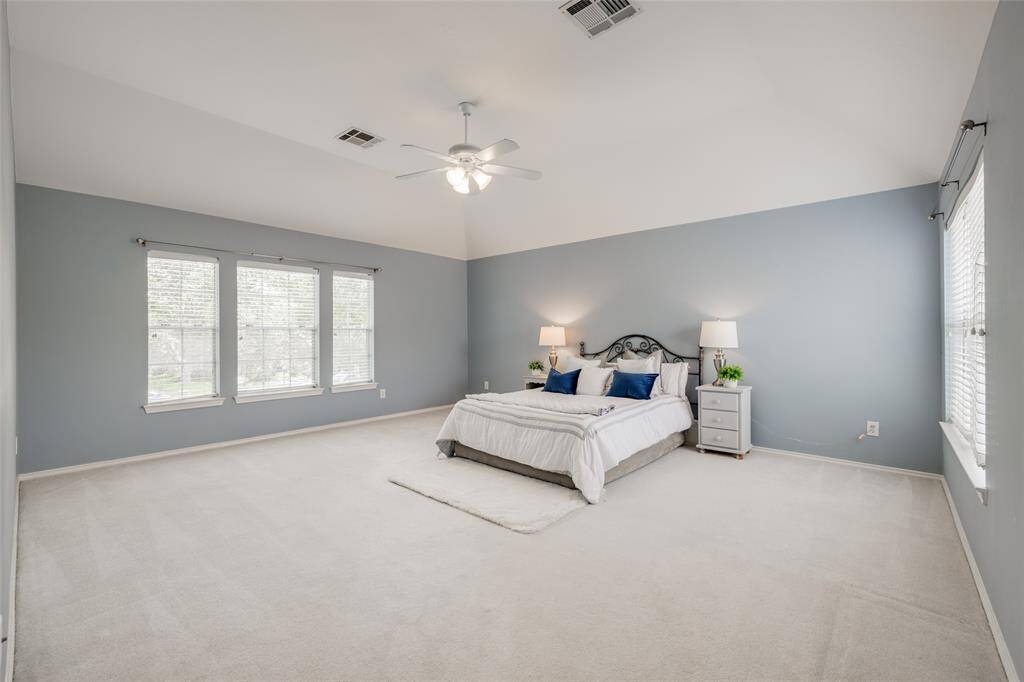 Huge Primary bedroom is a dream! Complimented by coffered ceiling, new black ceiling fan with light fixture, recent beautiful neutral paint throughout, carpet