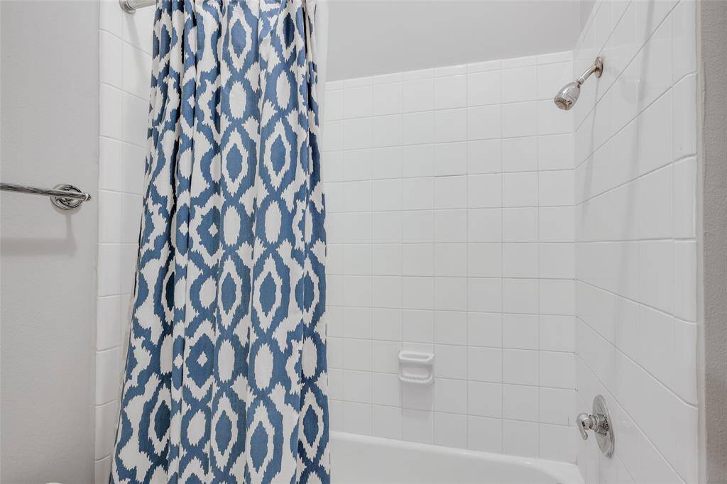 Second bathroom shower with white tile