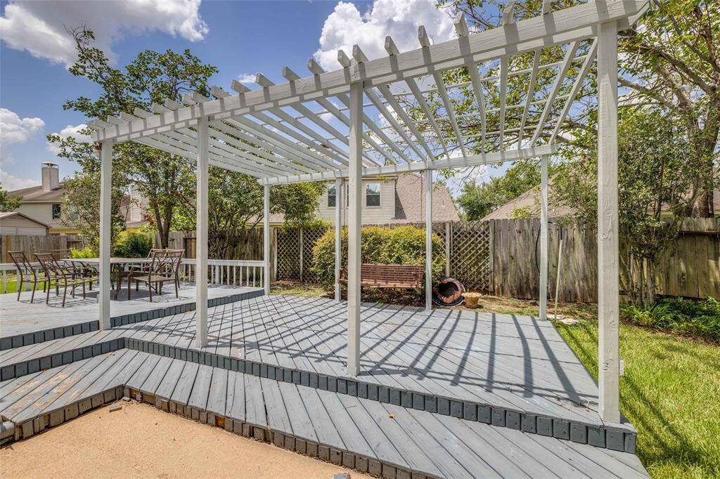 Decked patio extension surrounded by lovely landscaping.