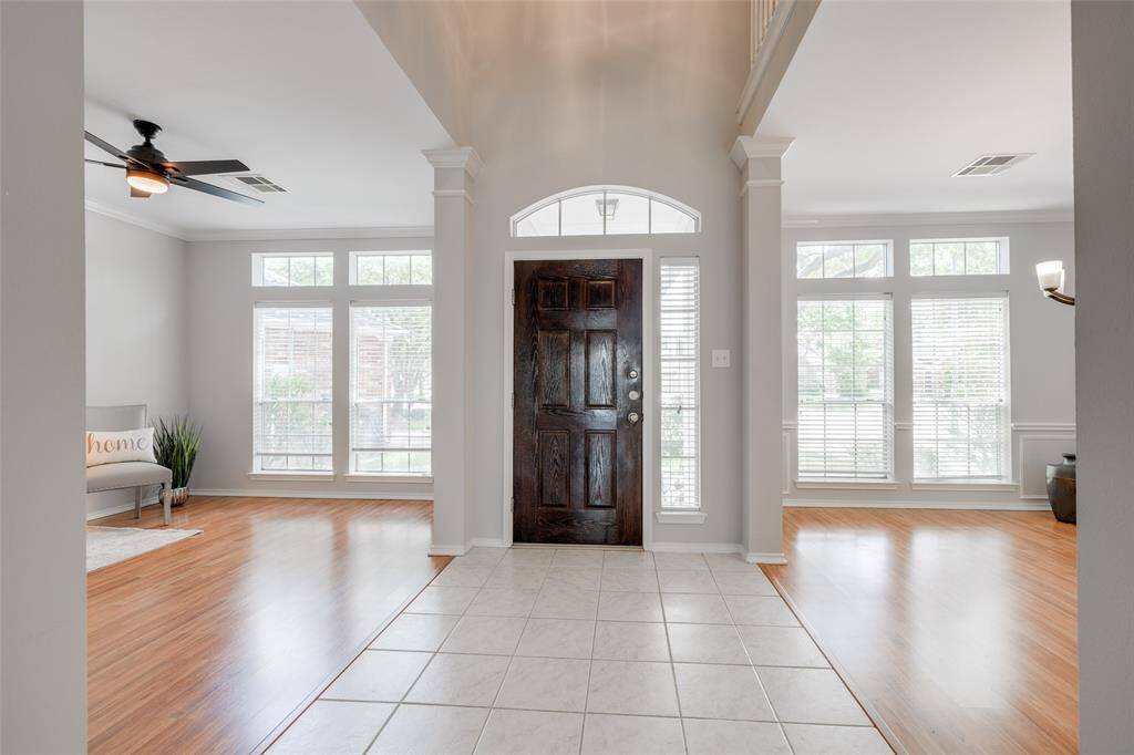Entry has two story high ceilings, tile flooring with lots of natural light