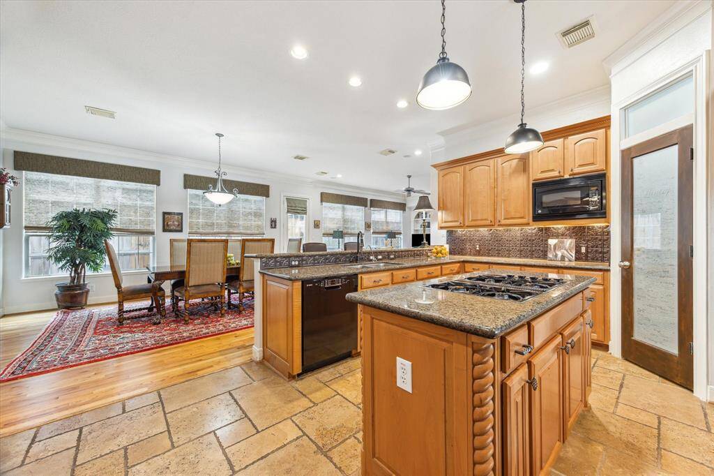 The open island kitchen has views to the front of the house and the rear.