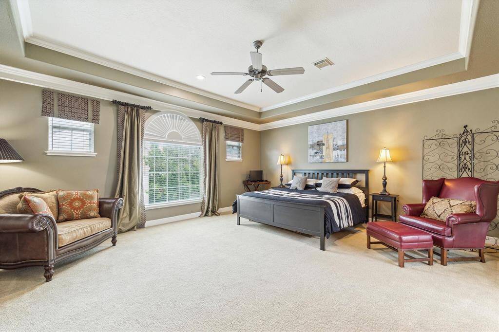 The large primary bedroom has room for a sitting area.  Two walk-in closets plus a private adjacent office or sitting room.