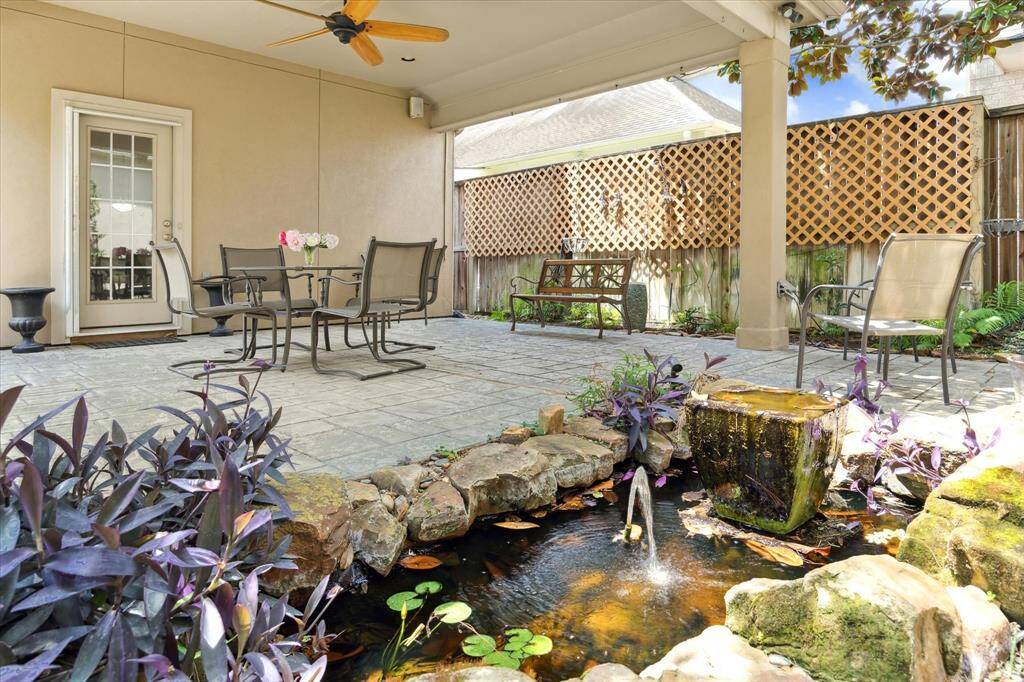 A koi pond with fountain is at the edge of the terrace.