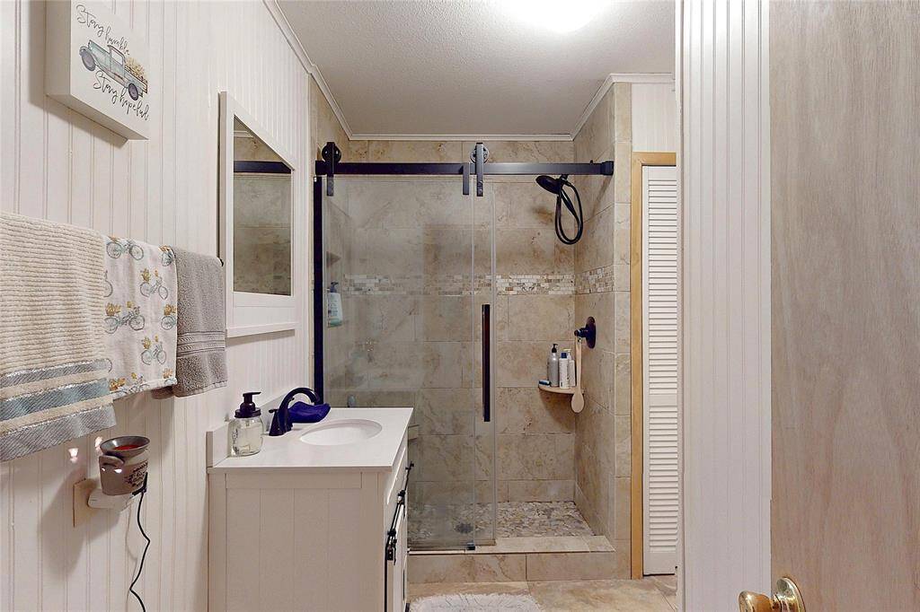Beautifully renovated bathroom with walk in shower and barn door