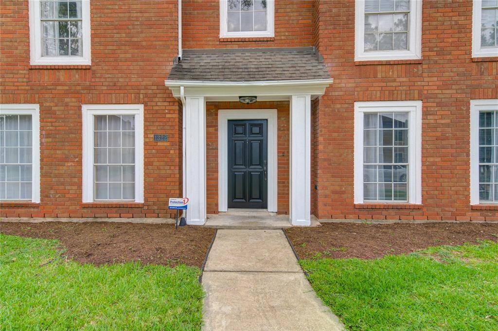Beautiful columns frame the recently painted front door.