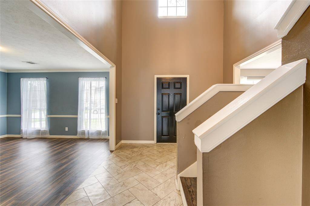 Two story foyer and recently painted front door.