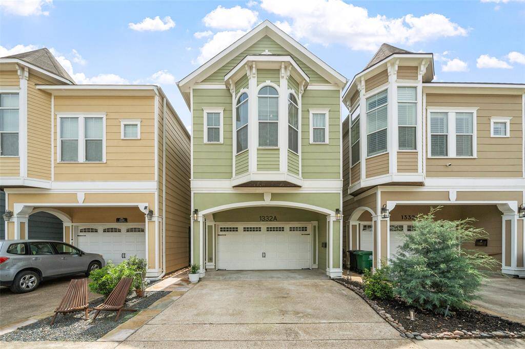 Charming multi-story townhouse with a distinctive green facade and white trim. Features include a two-car garage, elegant bay windows, and a small front garden. Located in a well-maintained, modern neighborhood.