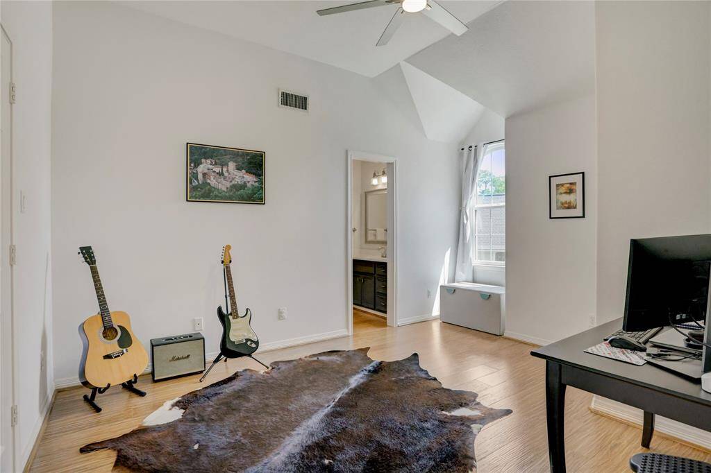 This bright secondary bedroom offers direct access to the Hollywood bath and is filled with natural light.