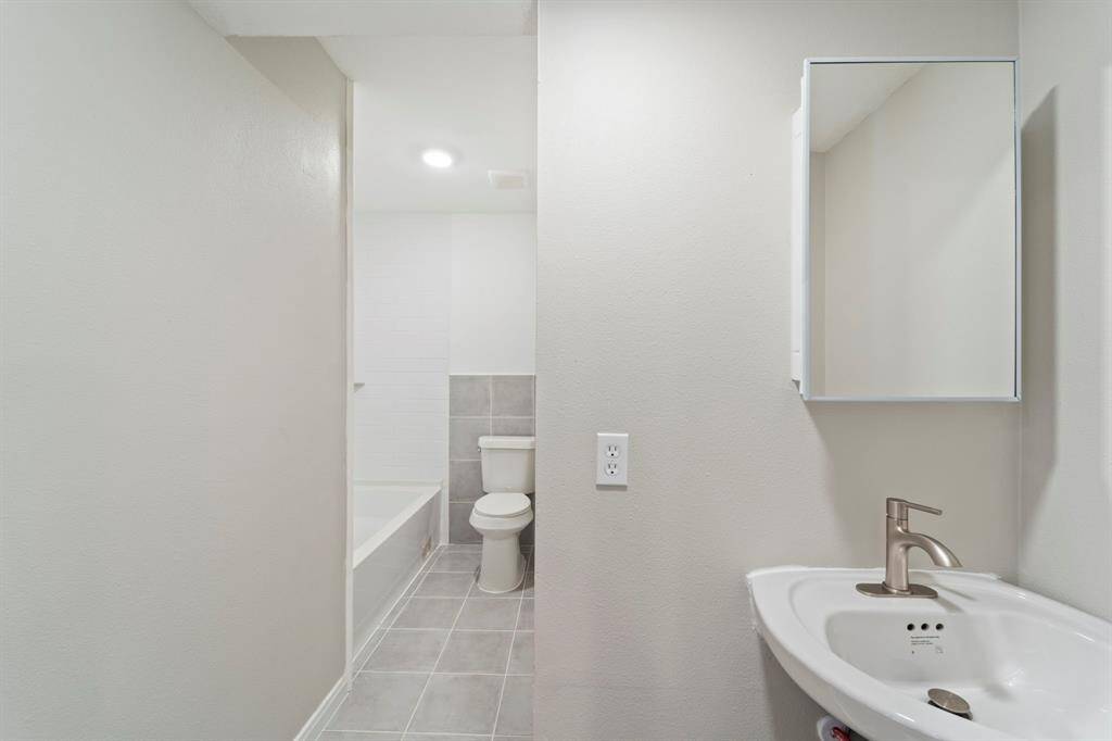 Bathroom which features a combo shower/tub.