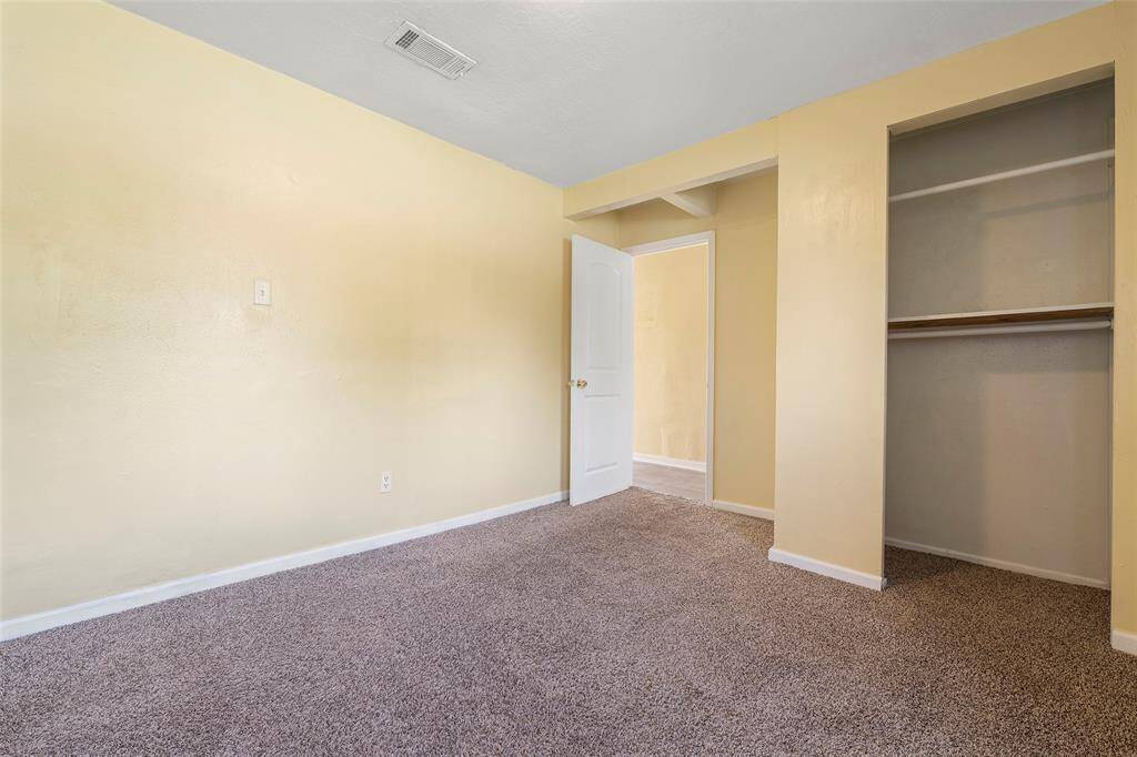 This bedroom features an open closet with plenty of room!