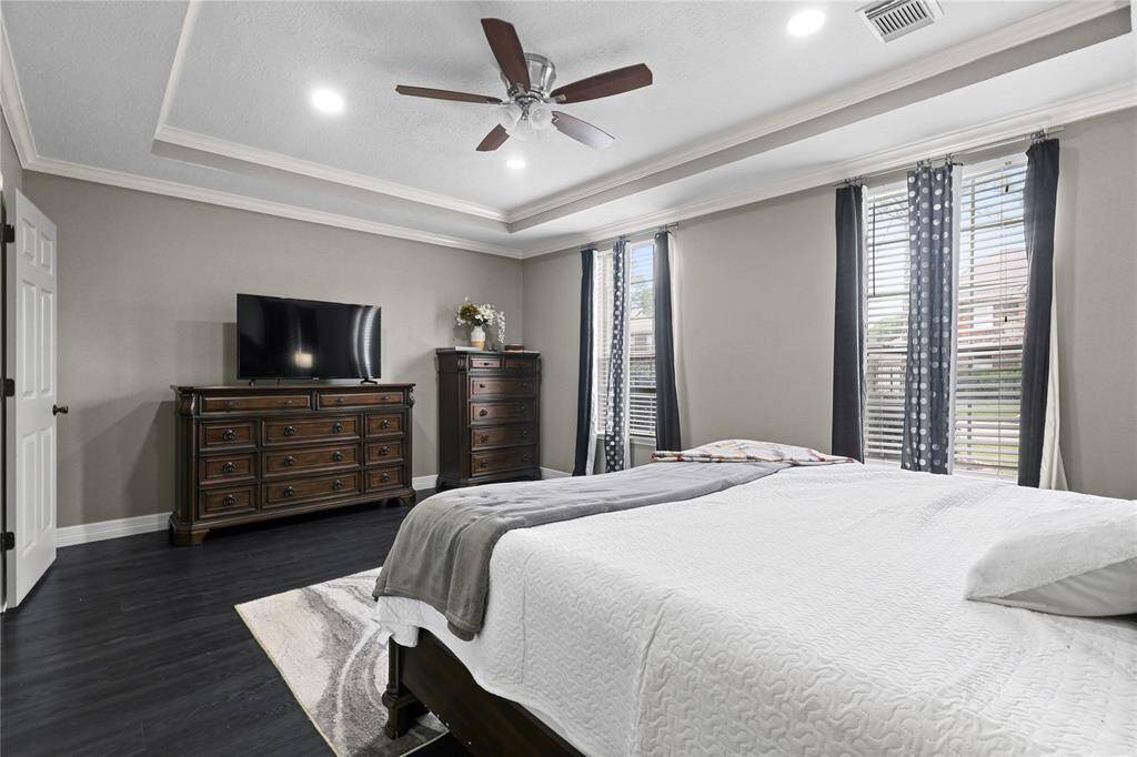 First floor Primary Suite, Tray Ceilings, bedrooms window look out to the pool