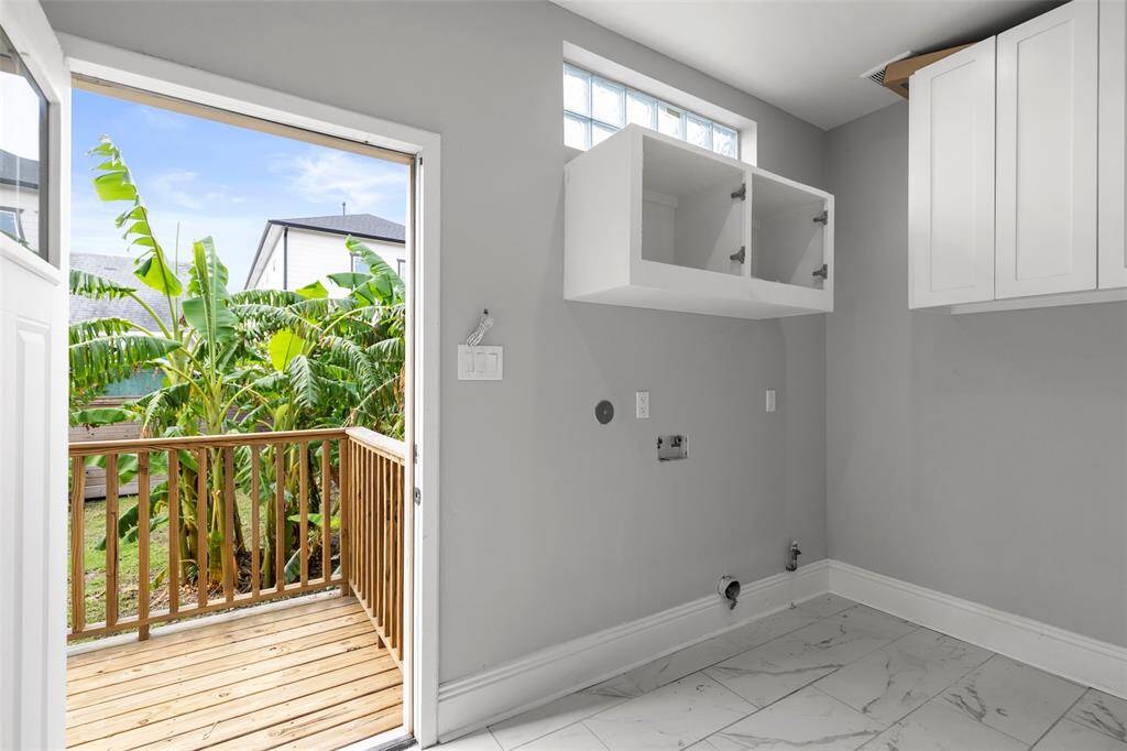 This is the first floor utility room, with the connections and access to the back wooden deck.