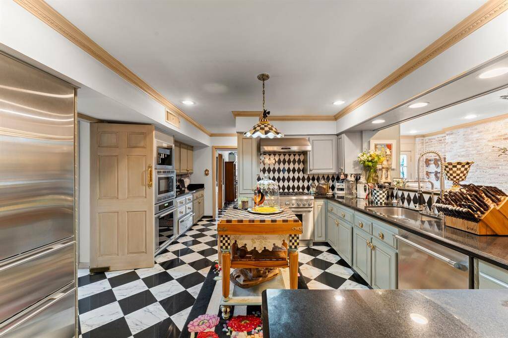 The chef's kitchen includes double ovens and a Sub Zero refrigerator equipped with four freezer drawers