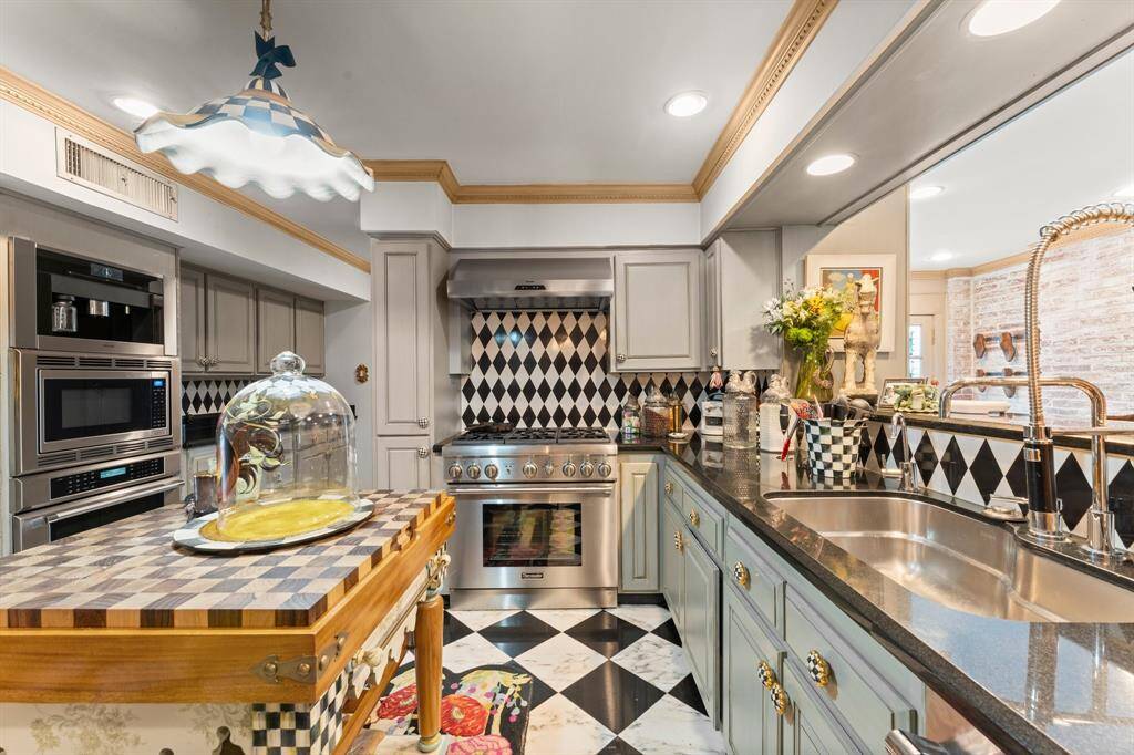 The che'fs kitchen also features a built in espresso maker and checkered marble flooring
