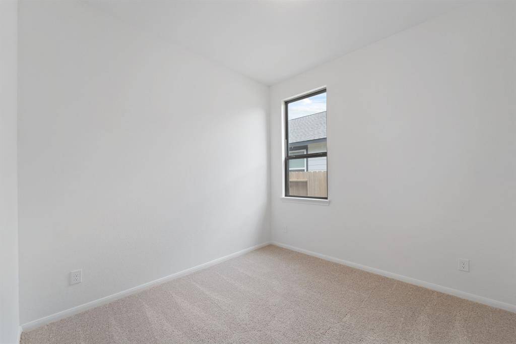 Your secondary bedroom features plush carpet, fresh paint, closet, and a large window that lets in plenty of natural lighting.