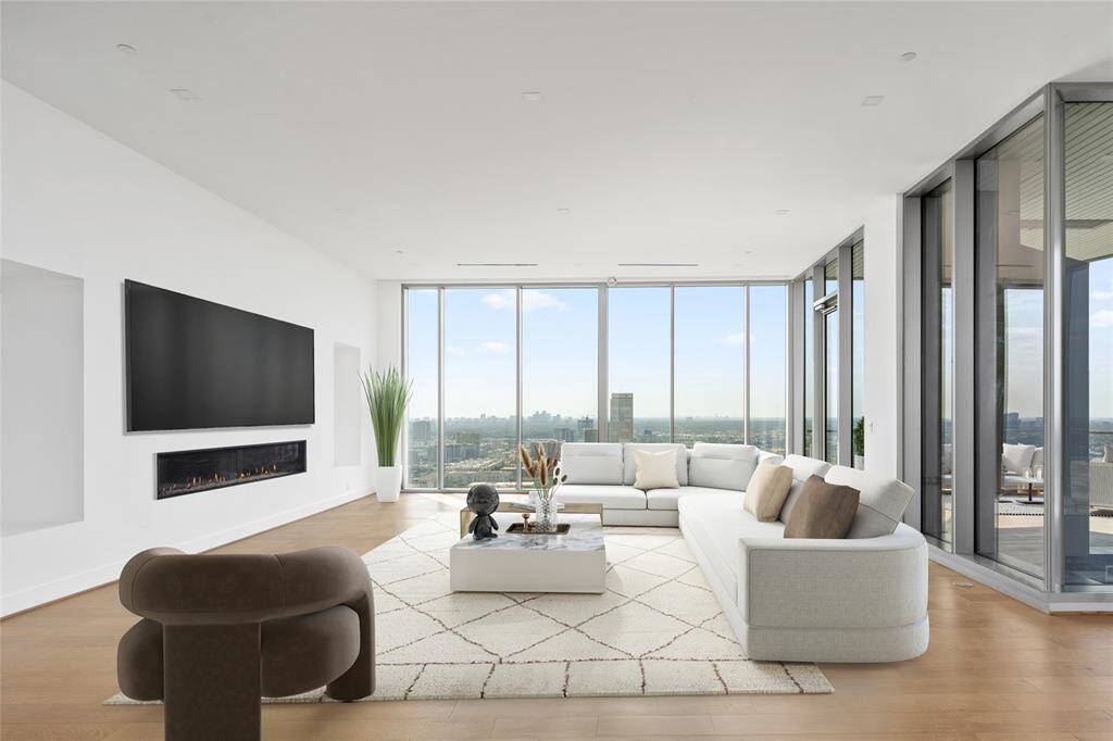 Living room features sweeping views of the sky line. The residence includes, engineered hard wood floors, fireplace and private pool. Virtually staged.Virtually Staged