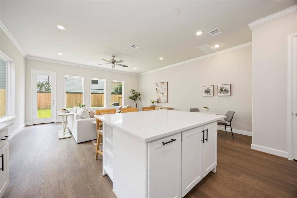 This huge island offers adjustable shelves, perfect for storing cookbooks or frequently accessed items, while providing a stunning view of the entire open-concept first-floor living space.