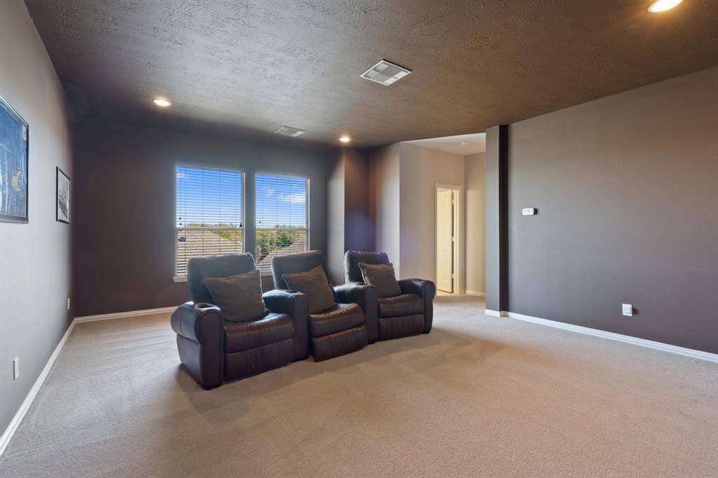 3rd floor media room with half bath in back right corner.