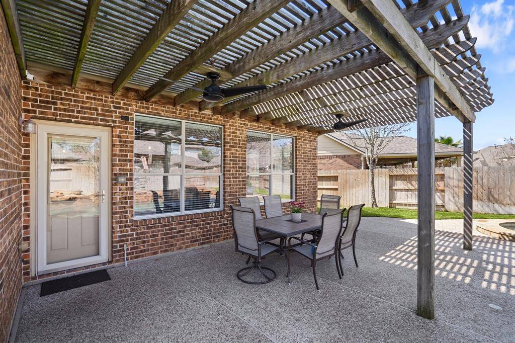 Covered back patio with the pergola allows you to escape the direct sun during the bright summer days.