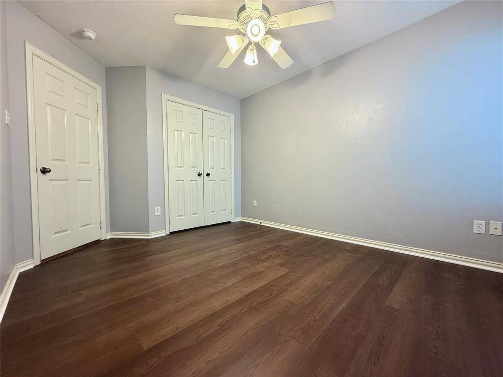 The third bedroom features LVP flooring, a ceiling fan, and a roomy closet.