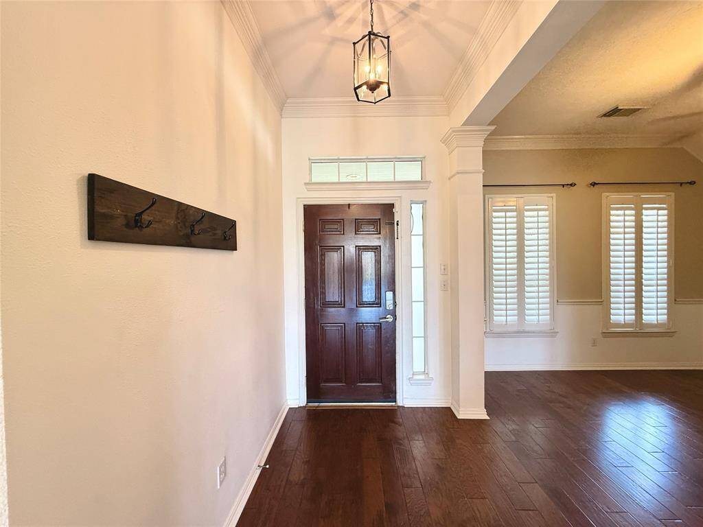 A bright welcome with high ceilings and timeless plantation shutters.