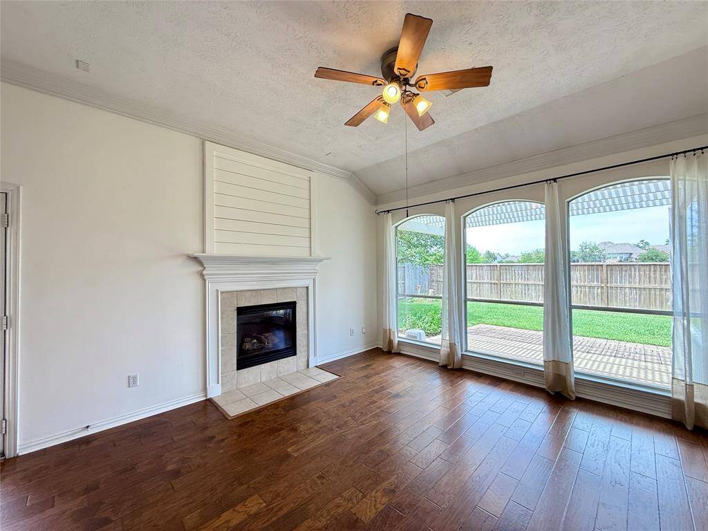 Gas fireplace surrounded by three large windows, bringing in plenty of natural light.