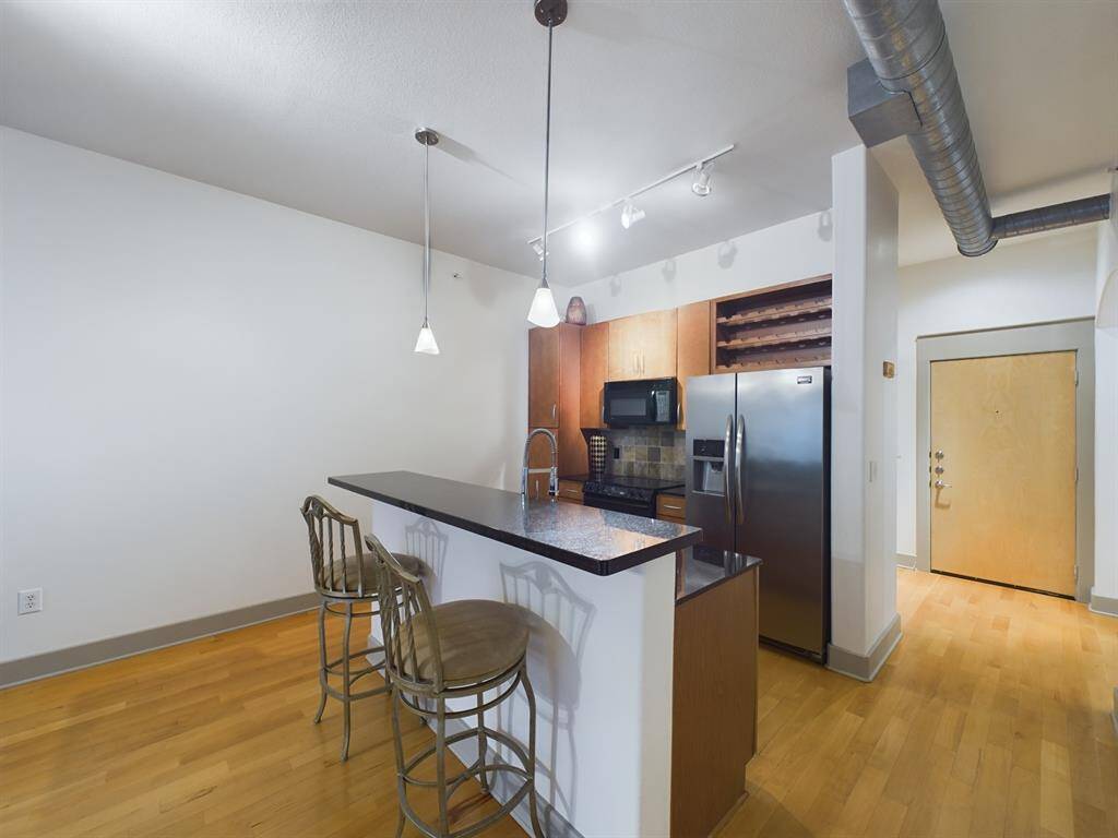 Electric Range, Microwave, French Door Refrigerator, Pantry, Wine Rack and Pendant Lighting