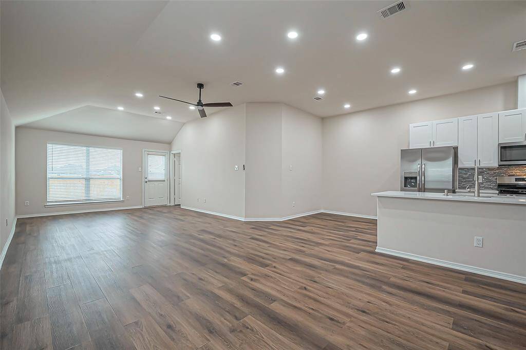 The kitchen and breakfast area overlook an expansive family room (31.6 x 13.2), creating a seamless flow for entertaining. With recessed lighting (2024), this generous space is perfect for gatherings, offering plenty of room for family and friends to relax and enjoy.
