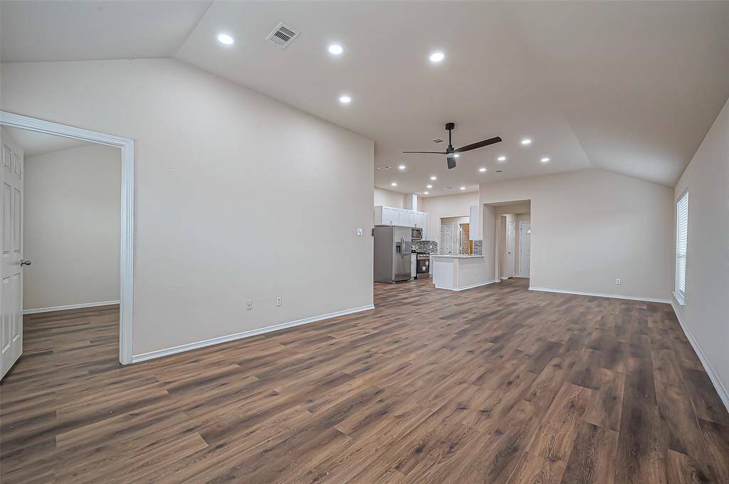 Another view of the expansive 31.6 x 13.2 family room shows just how perfect this open-concept space is! It offers plenty of versatility for any layout you desire. A doorway on the left leads to the owner's suite at the back of the home, providing a private retreat away from the main living areas.