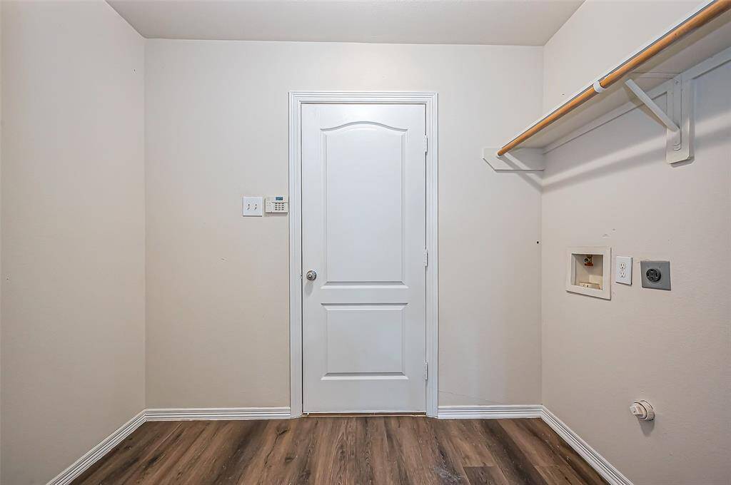 The utility room, located toward the front of the house, measures 8.6 x 5.5 and offers space for a full-size washer and dryer, as well as a second refrigerator or upright freezer. It is plumbed for both electric and gas dryer connections. A convenient shelf and clothes rod are positioned above the units for added storage. A door leads to the attached 2-car garage. The home also features a natural gas on-demand hot water heater for energy efficiency and endless hot water.