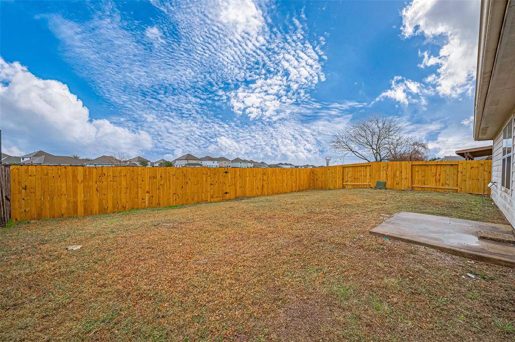 From the back door, step onto a concrete patio, ideal for an outdoor grill and entertaining. Two sides of fencing were replaced in 2024, and the backyard is fully fenced, providing privacy and a secure space for kids and the family dog to run and play.