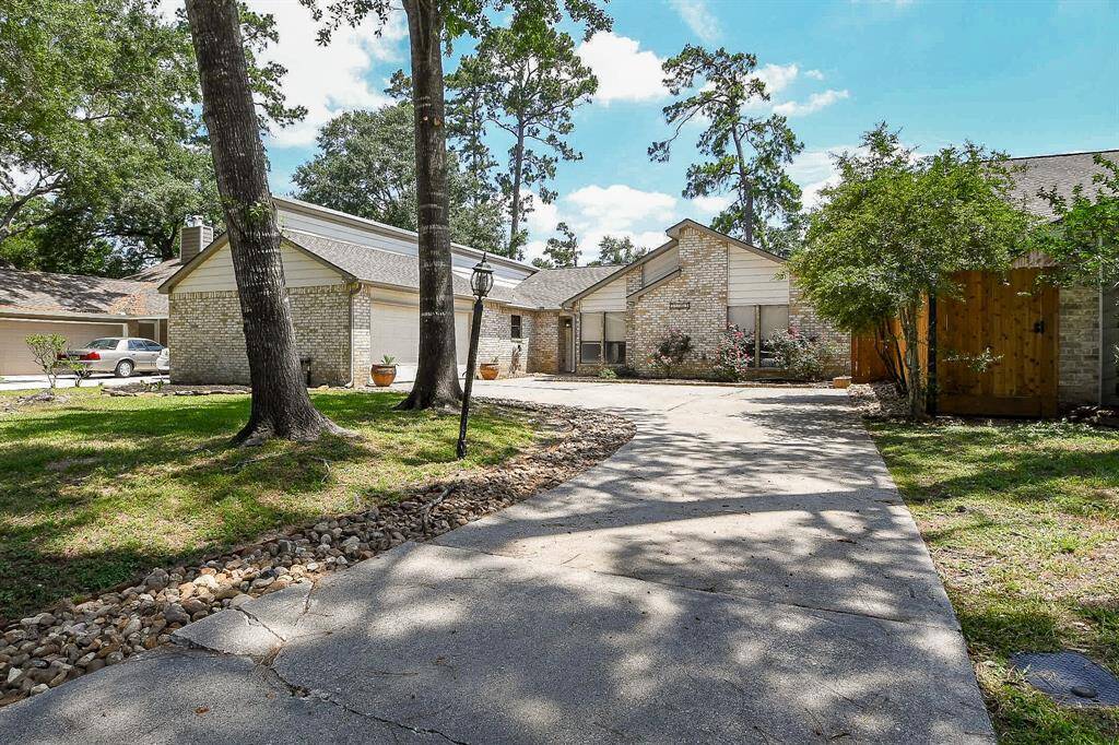 Charming single-story brick home with a spacious driveway nestled among mature trees. The front yard features a well-maintained lawn and a cozy entrance, offering great curb appeal in a peaceful neighborhood setting.