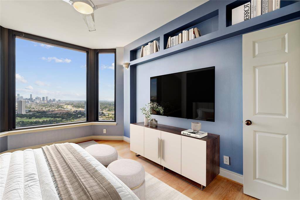 Guest bedroom with hardwood floors and 39th floor views! Image shown virtually staged.