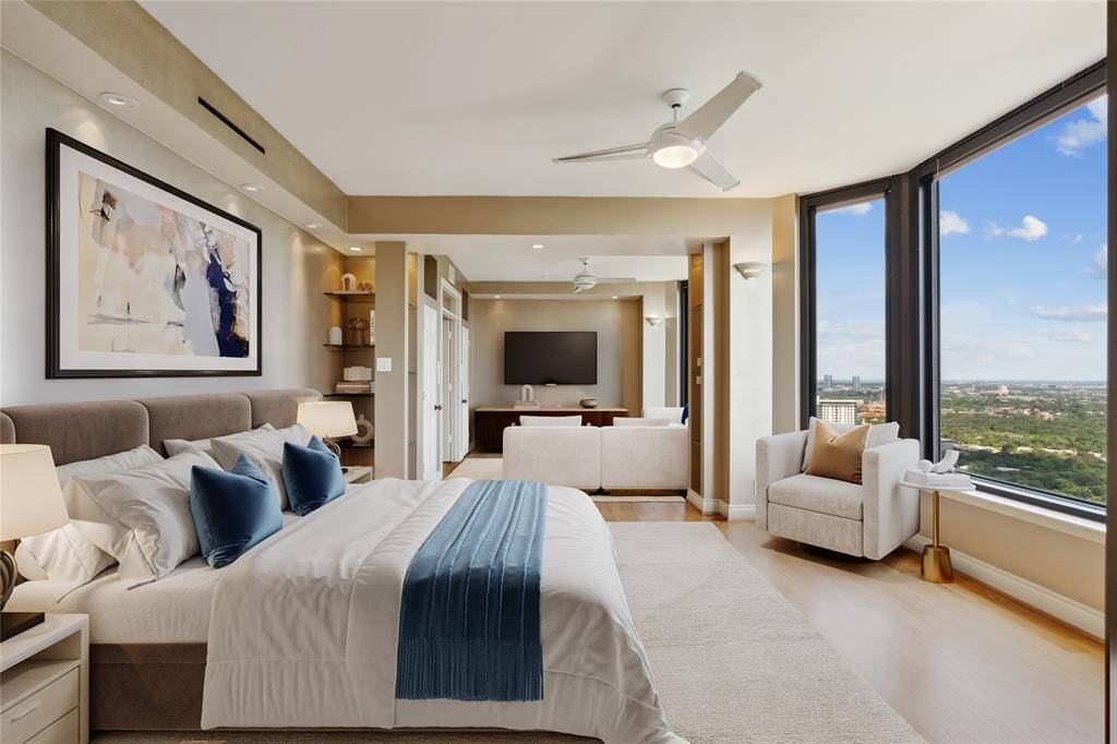 Primary suite on the 39th floor with sitting room, panoramic views and automatic shades throughout. Image shown virtually staged.