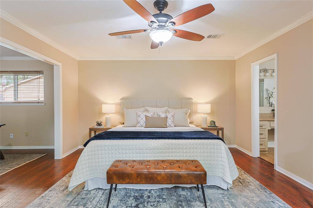 Large master bedroom with high ceilings.