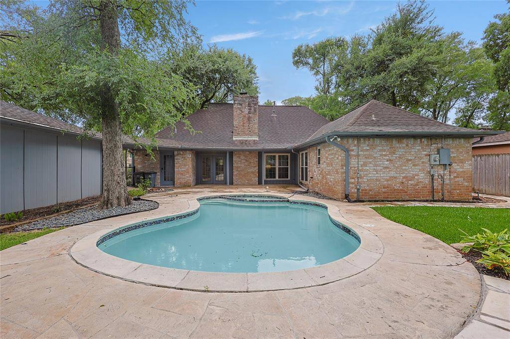 Imagine hosting summer barbecues in this spacious backyard with friends gathered around the pool!