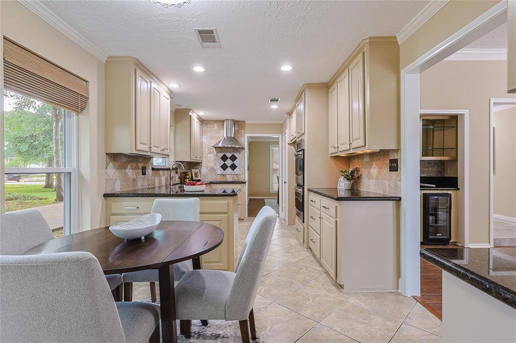 There's plenty of storage in this kitchen, featuring granite countertops and stainless steel appliances, ideal for cooking and entertaining.
