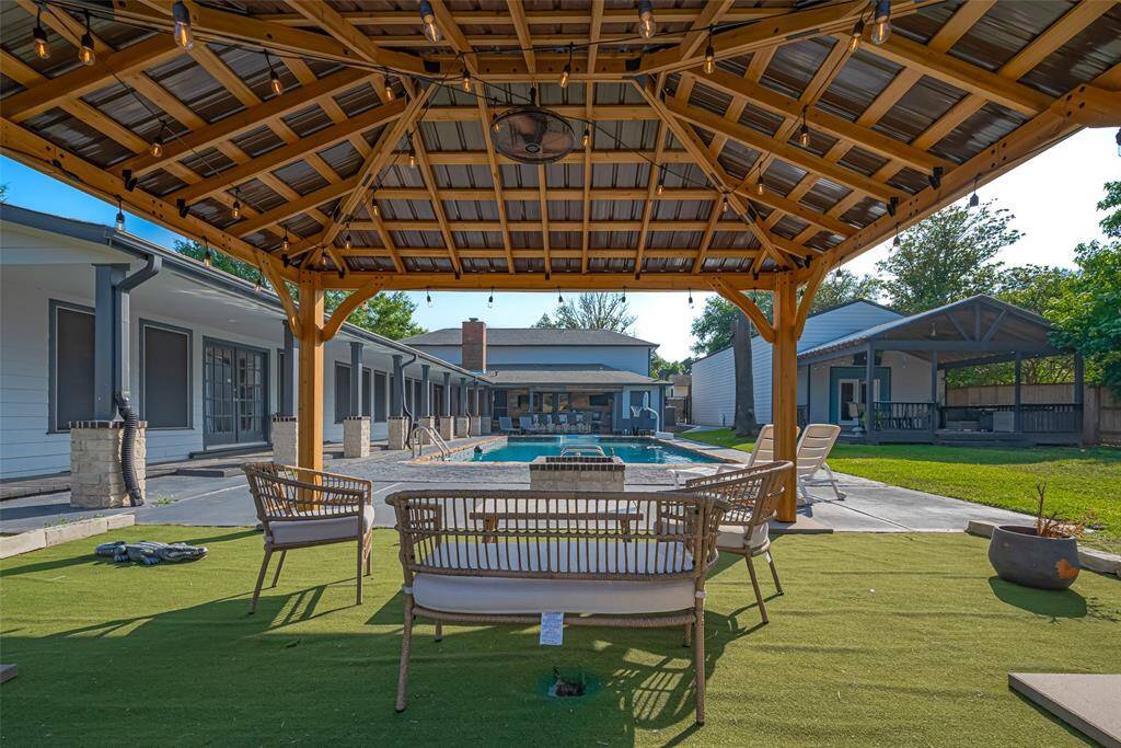 This backyard oasis pool area with a stylish pergola, perfect for outdoor relaxation and entertainment.