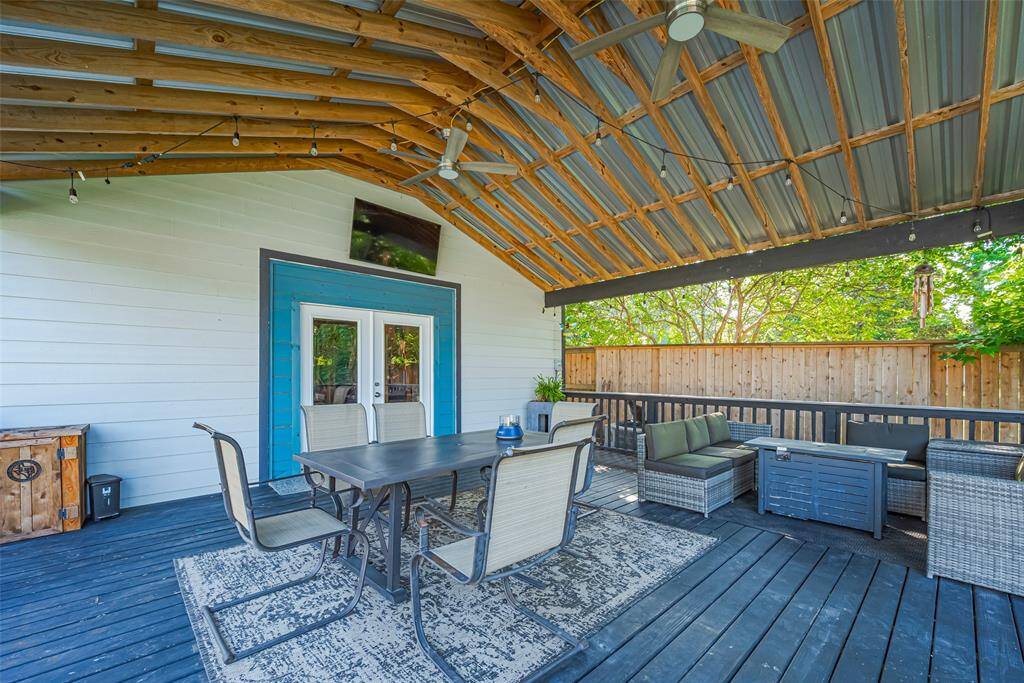 Located off the workshop, this patio with exposed beams is a great place to cool off in the shade while overlooking the pool area.
